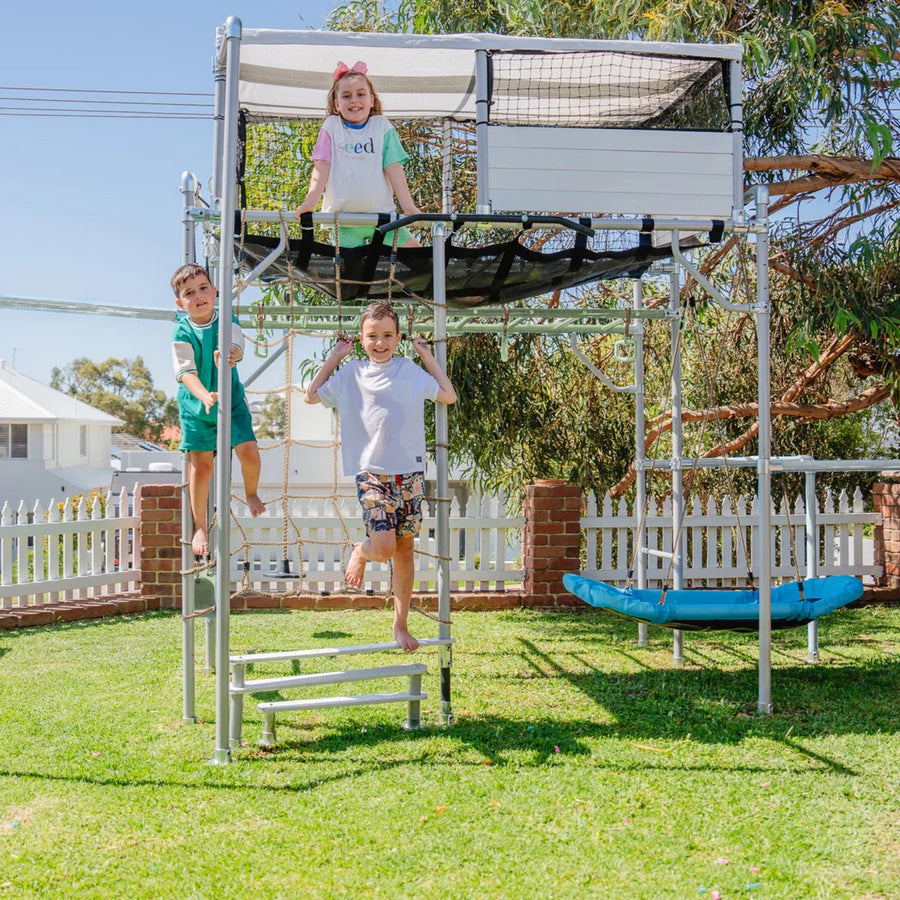 Children playing on a Growplay cubby house and monkey bars in an Australian backyard