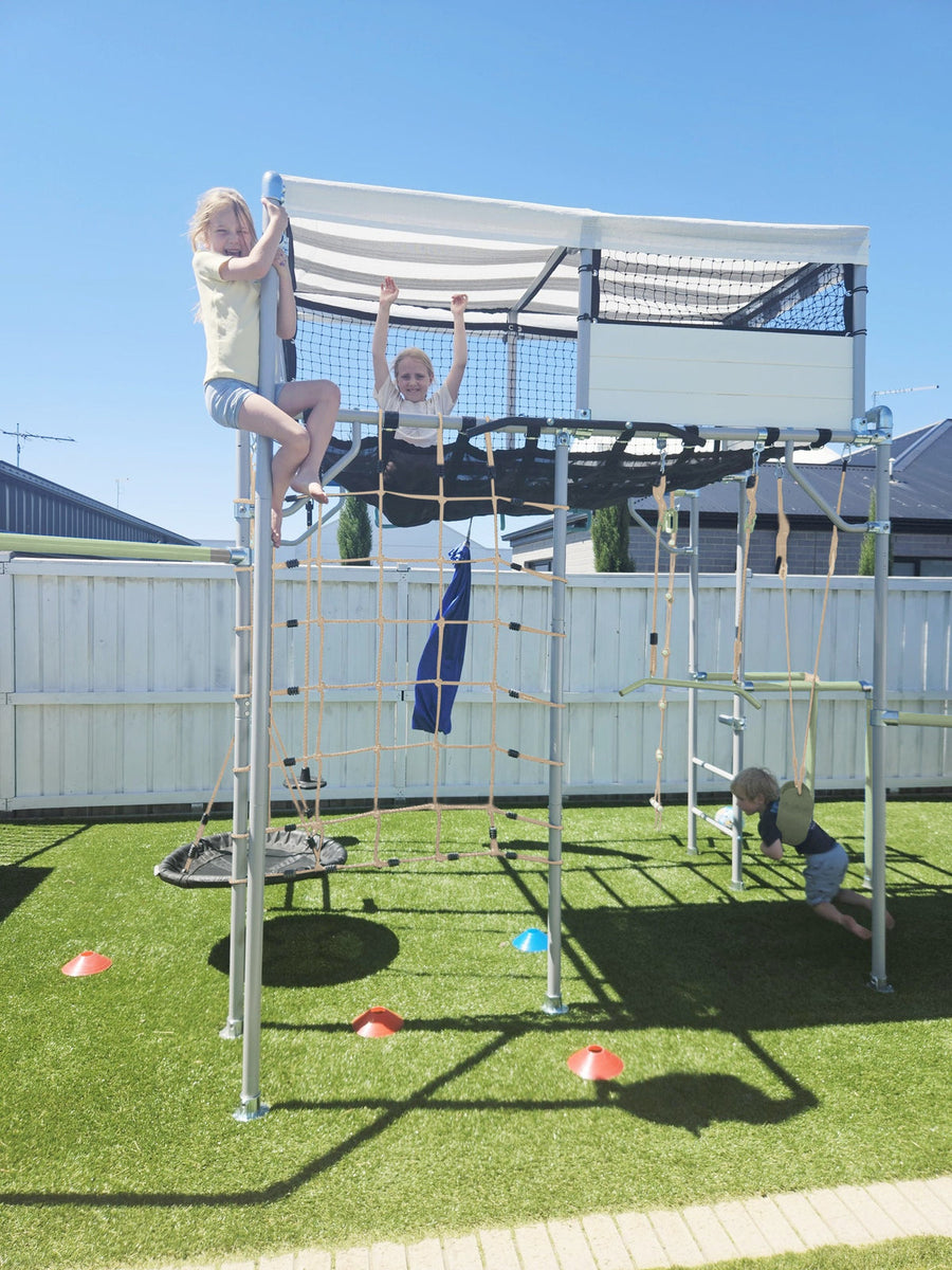 Kids playing on a Growplay cubby house in an Australian backyard