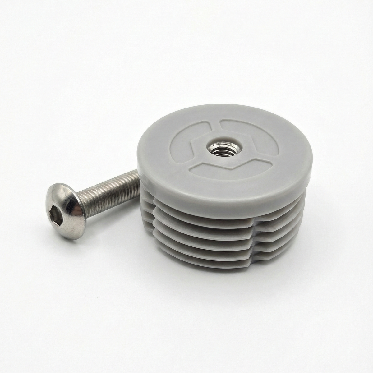 Gray plastic component with a screw on a white background