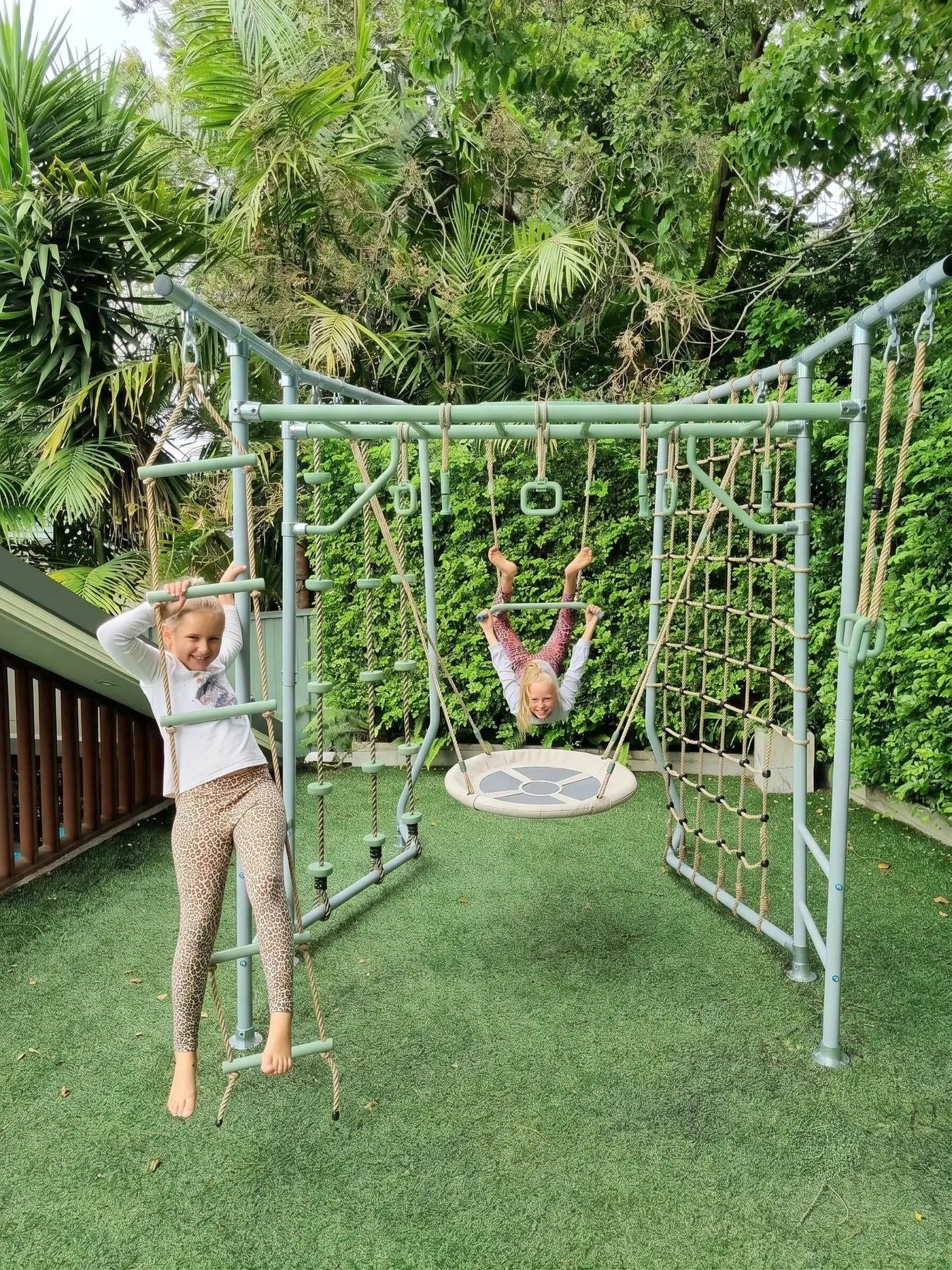 The Compact green frame in a real backyard with kids playing