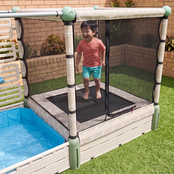 Child bouncing on The Launch Pad trampoline inside the net enclosure